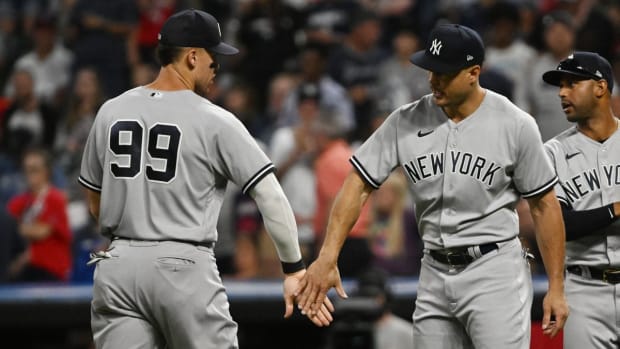 Jul 2, 2022; Cleveland, Ohio, USA; New York Yankees center fielder Aaron Judge (99) and designated hitter Giancarlo Stanton (27) celebrate after the Yankees beat the Cleveland Guardians at Progressive Field. Mandatory Credit: Ken Blaze-USA TODAY Sports